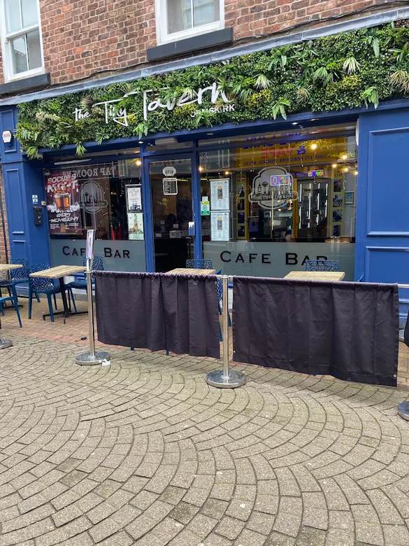 The Tiny Tavern shopfront on Burscough Street with outdoor tables